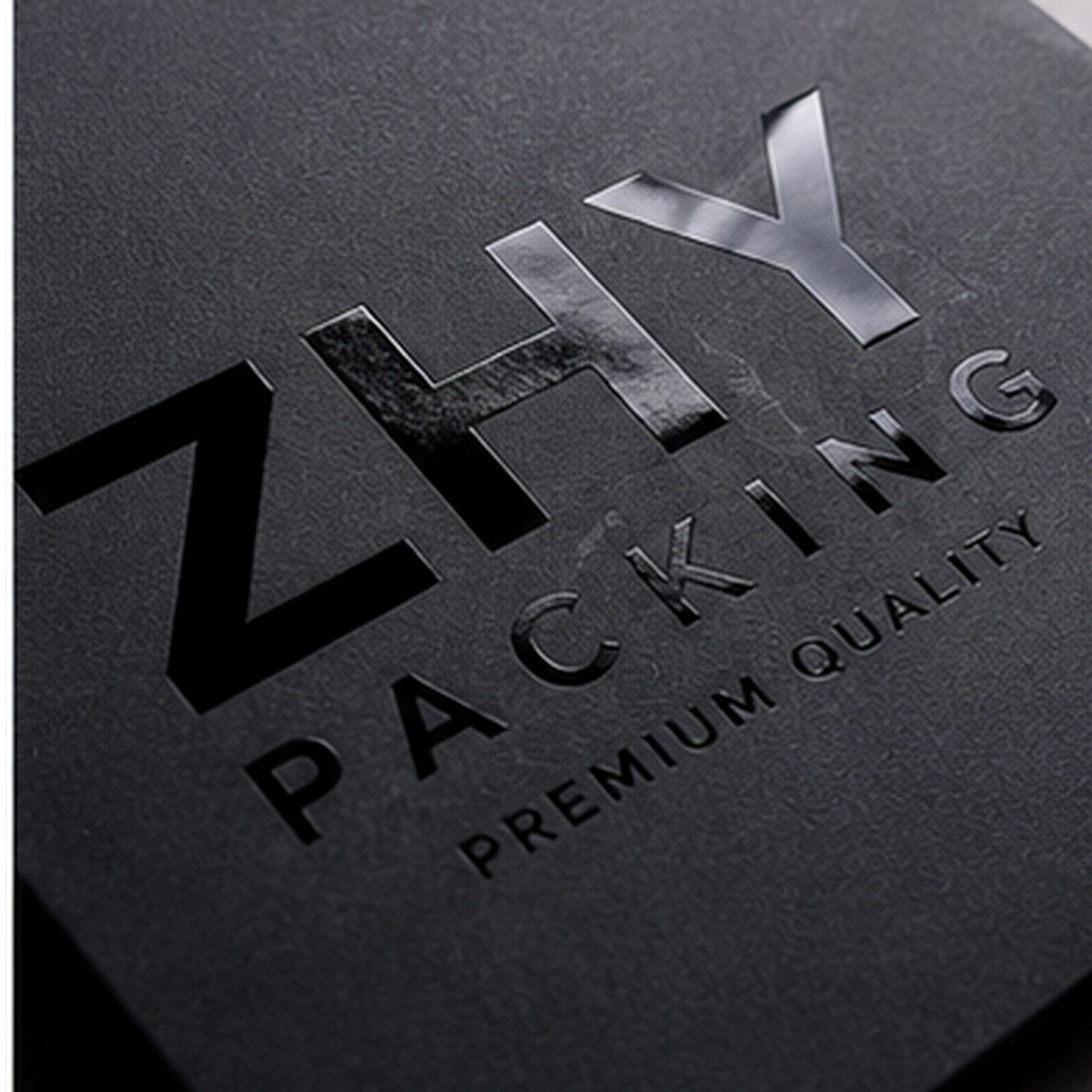 Spot UV black paper box logo detail for beauty packaging finish approval
