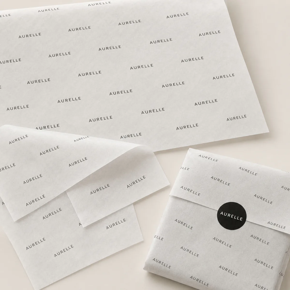 Illustrative product presentation of repeated-logo printed tissue paper shown flat and folded